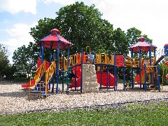 Katherine (Kat) McDougal Wheeler McCandless climbing the wall at Canandaigua Elementary playground