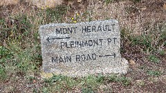 sign <-- Mont Herault, Pleinmont Pt; Main Road -->
