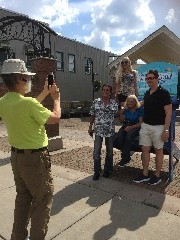tourists in front of the Canandaigua chair; Canandaigua, NY